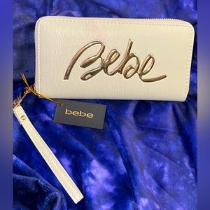BEBE long wristlet/wallet. Beautiful cream color with gold-tone hard . NWT